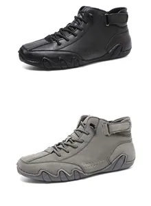 Detail of high-top casual shoes with lace-up and velcro closure in black and grey