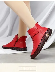 Detail of red leather boots showing textured cowhide and durable hand-stitched thick soles