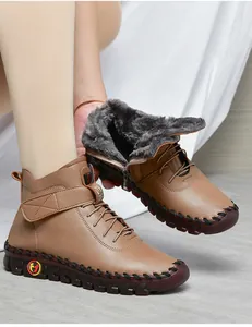 Detail of tan winter ankle boots showing warm faux fur lining and side zipper closure