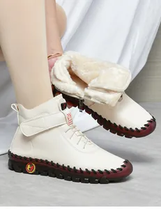 Detail of warm faux fur lining and beige leather upper on winter ankle boots