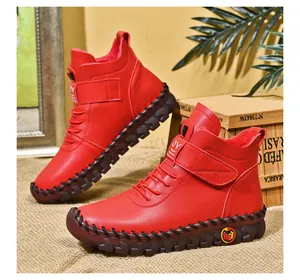 Detail of red high-top winter boots with thick rubber sole and warm lining