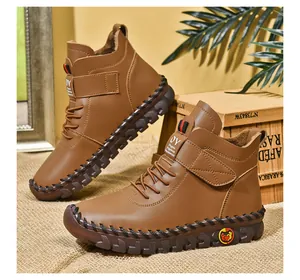 Brown high-top winter boots featuring durable hand-stitched soles and warm fleece lining