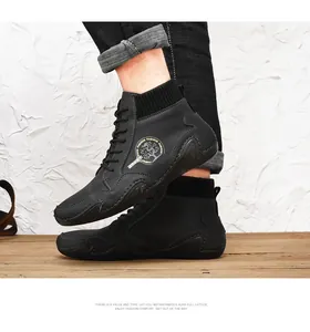 Detail of black leather mid-top casual boots with knitted collar and logo emblem