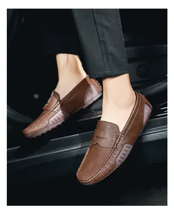 Close-up of brown leather penny loafers with rubber pebble sole detail on car doorstep