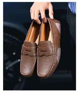 Detailed view of brown leather loafers featuring classic penny strap and pebble driving sole