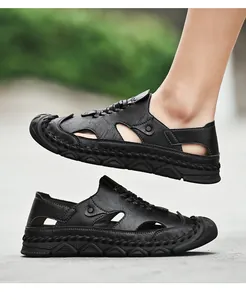Close-up of black leather men's outdoor sandals with breathable cutout design and stitching