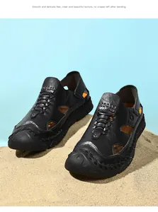 Detailed view of black genuine leather sandals with breathable cutouts and contrast lining