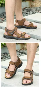 Detailed close-up of brown leather men's sandals with triple hook-and-loop straps and thick sole