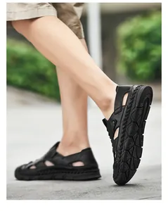 Detail view of black leather sandals with breathable cutouts and anti-slip rubber soles