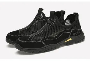 Dettaglio ravvicinato delle sneaker in mesh nero traspirante con inserti gialli sulla suola