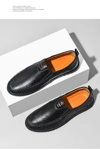 Detail of premium black leather loafers with vibrant orange lining and visible stitching