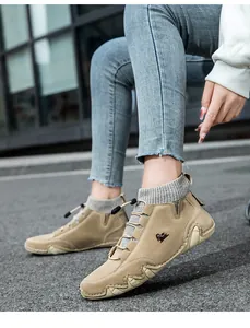 Close-up of khaki suede casual boot featuring a gray knit sock collar and rugged sole