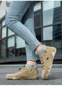 Detail of khaki suede boots with grey knitted sock collar and wave-patterned rubber sole