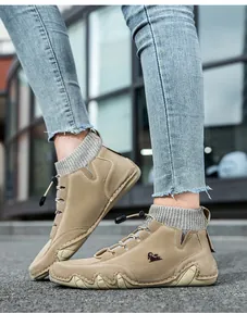 Detail of khaki high-top casual outdoor boots with knitted collar and bungee laces