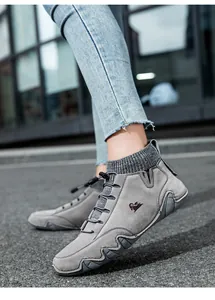 Street view of gray suede boots with knitted sock collar and elastic drawstring adjustment