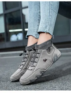 On-foot view of grey sock-style boots with toggle laces and knitted collar detail