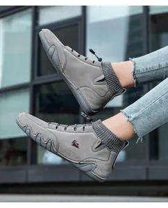 Detailed view of grey minimalist barefoot high-top sneakers with flexible segmented soles