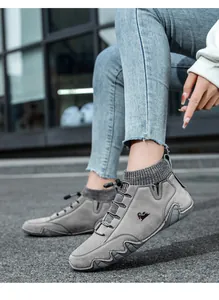 Detail of grey nubuck leisure boots with knitted collar and wave-patterned rubber sole