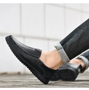Detail of premium black lychee leather loafers with white hand-stitching and soft sole text