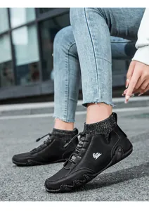 Detail shot of black leather sock sneakers with elastic knit collar and quick-lace toggle