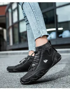 Close-up of black lace-up boots with knit collar and anti-slip rubber traction sole