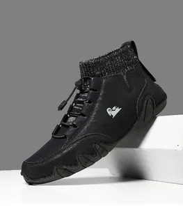Detail of black high-top boots featuring a gray knit collar and wavy textured sole