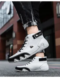 Detail of high-top casual sneakers with black and white leather contrast and velcro strap