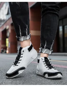 Close-up of black and white high-top sneakers with a stylish mixed material finish
