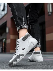 Close-up of white and grey leather high-top sneakers with perforated details and urban style
