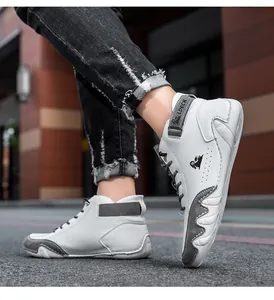 Detail view of high-top casual sneakers with velcro strap and white synthetic leather