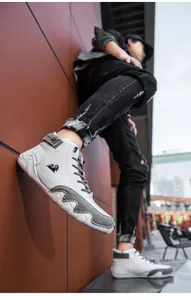 Macro view of white high-top leather sneakers with grey suede panel and ram logo detail
