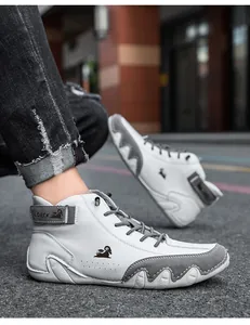 Detailed macro view of white and grey high-top sneakers with a wavy rubber sole