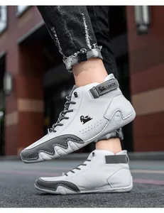 Detail showing the white and grey high-top sneaker with LDECK strap and wavy rubber sole
