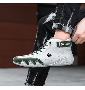 Detail of high-top casual shoes featuring white leather and green suede contrast stitching