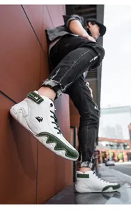 Macro view of men's high-top sneakers showing green suede stitching and LDECK velcro strap