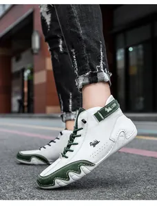 Detail of high-top white and green sneakers featuring ankle velcro strap and suede texture
