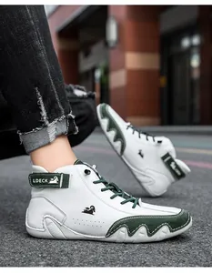 Detail of white leather and green suede high-top sneakers with Velcro strap design