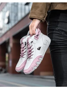 Detail of high-top sneakers showing pink suede panels and LDECK velcro ankle straps