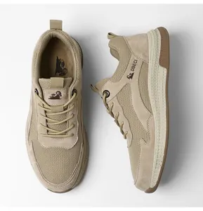 Close-up of khaki mesh and suede panels with non-slip rubber sole on casual sneakers