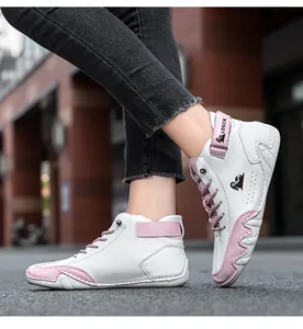 Detail of high-top casual sneakers in white and pink leather with Velcro ankle strap
