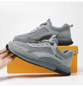 Detail of grey suede and breathable mesh panels on casual men's outdoor sneakers