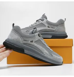 Detail of grey leather and breathable mesh men sneakers with DBECI logo on orange box