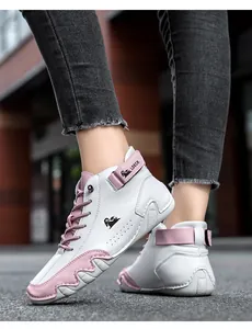 Close-up of white and pink high-top women's sneakers with LDECK logo and side strap details