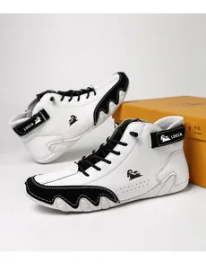 Detail of high-top leather sneakers featuring black suede panels and LDECK branding logo