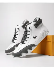 Macro detail of high-top sneaker showing white leather and grey suede textures