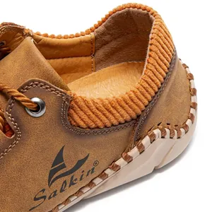 Detail of brown leather shoe showing orange corduroy collar and handcrafted stitching