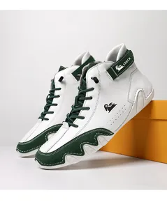 Detail of high-top sneakers showing green suede panels and white leather wave design