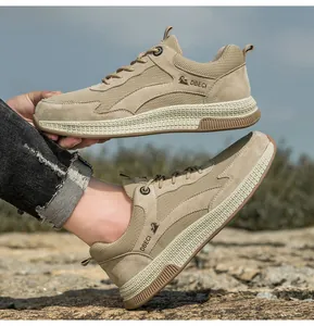 Close-up of khaki leather mesh sneakers featuring anti-slip rubber soles on rocky terrain