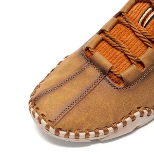 Detail of handmade stitching and corduroy fabric on brown leather casual shoes