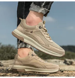 Detail of khaki leather mesh sneakers with durable rubber sole on rocky outdoor terrain
